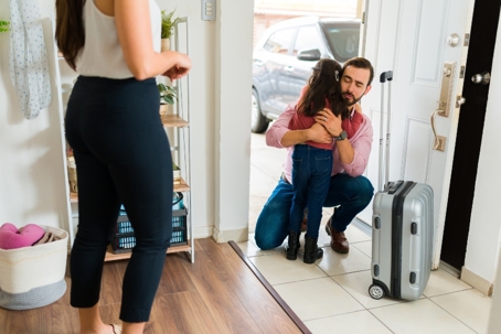 Little girl hugging her dad goodbye