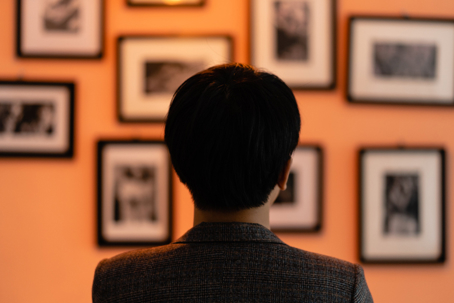 collector looking at framed fine art