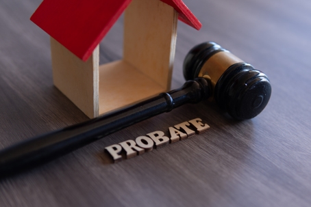 Image of a wooden house with a gavel and a probate sign