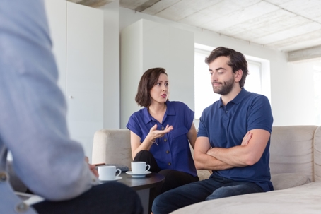 couple in serious discussion with a professional