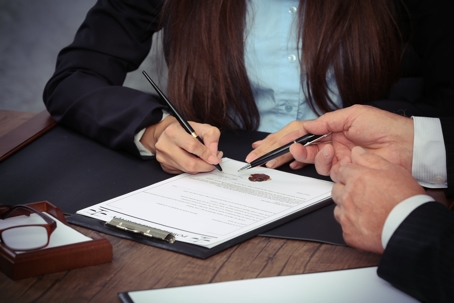 Woman signing document